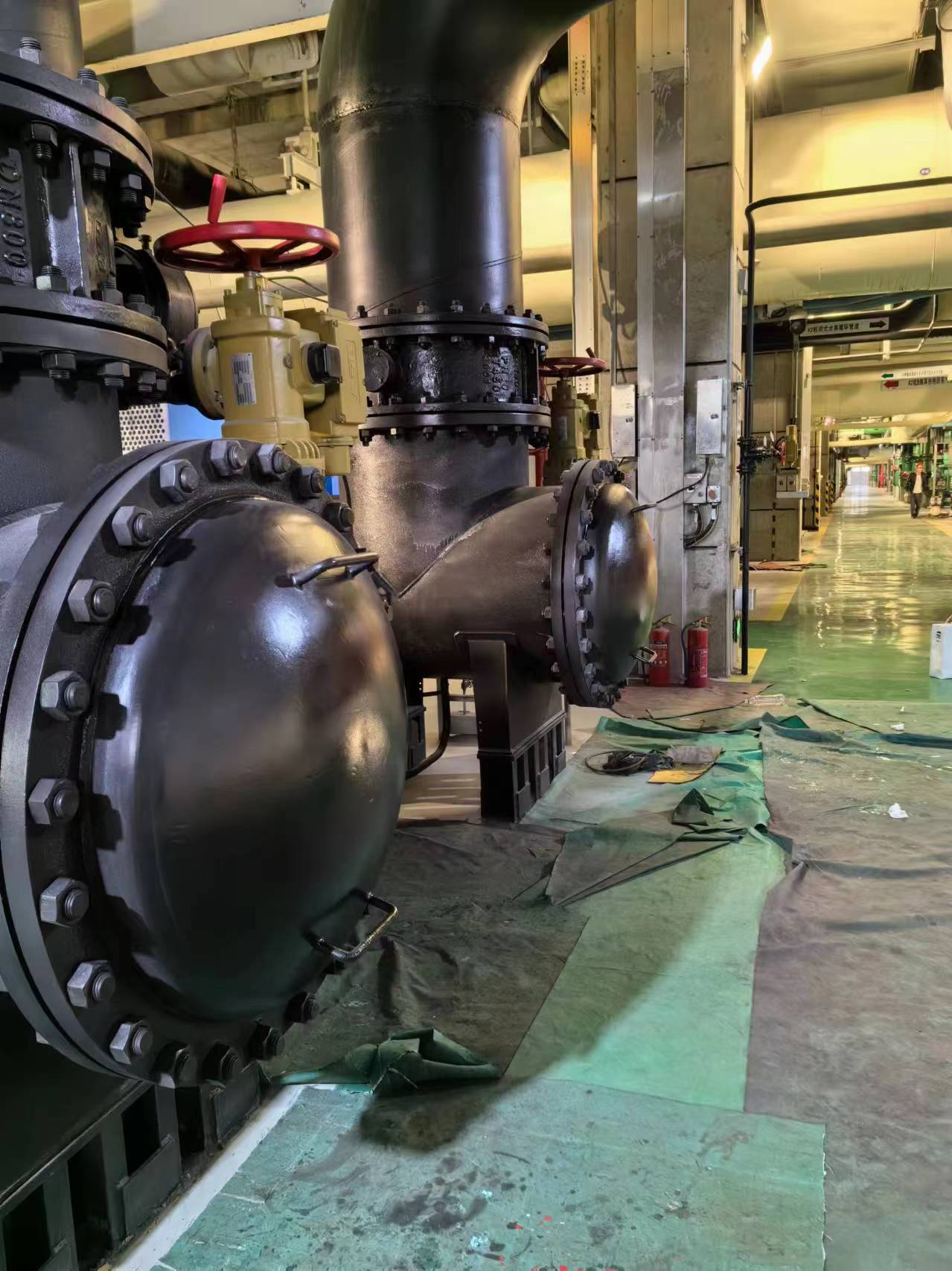 Coated large-bore pipework and valves inside a power plant